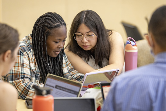 Students look at textbook