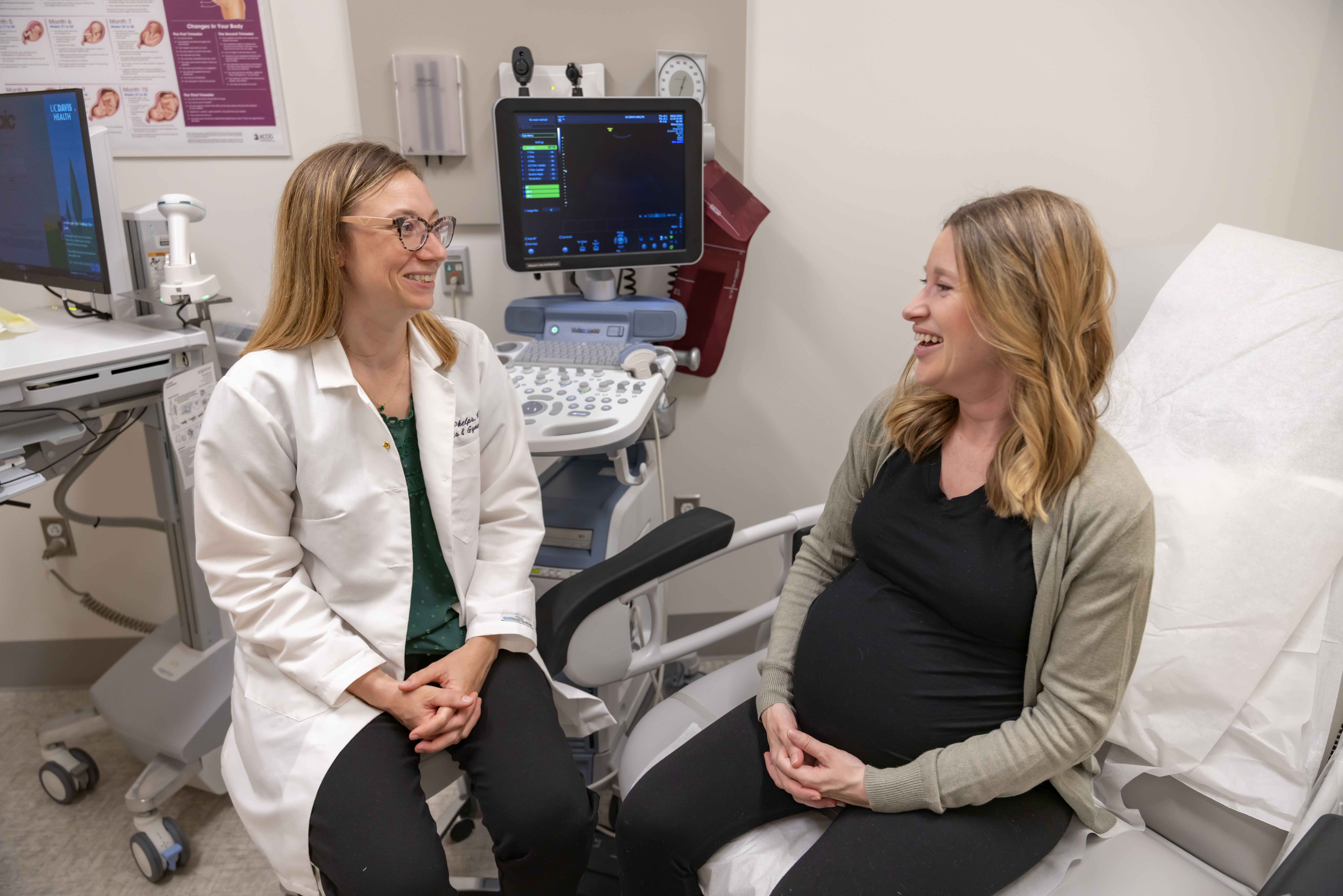 Pregnant woman and UC Davis physician smiling. 