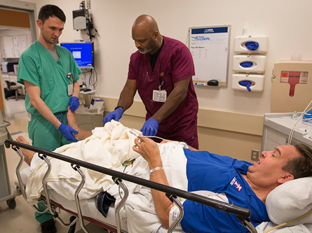 Healthcare workers with a patient in the emergency room.
