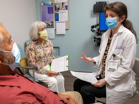 A doctor consulting with patients.