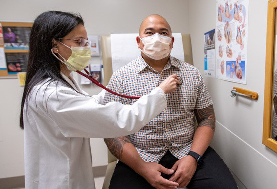 Cardiologist examining a patient.