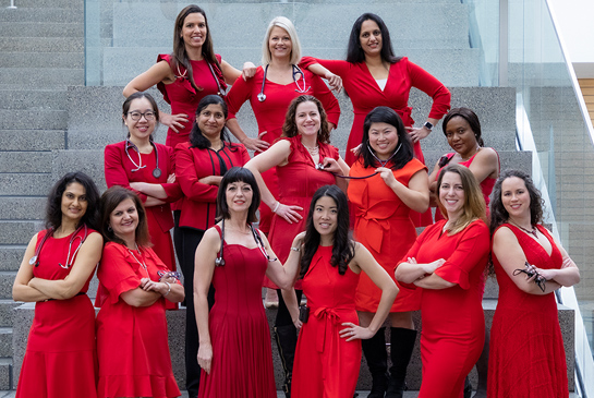 A group of women doctors showing off unique red dress designs