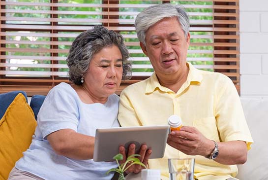 elderly couple viewing member handbook