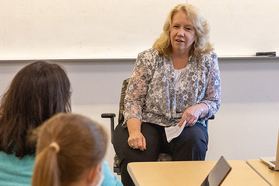 An instructor speaking to students.