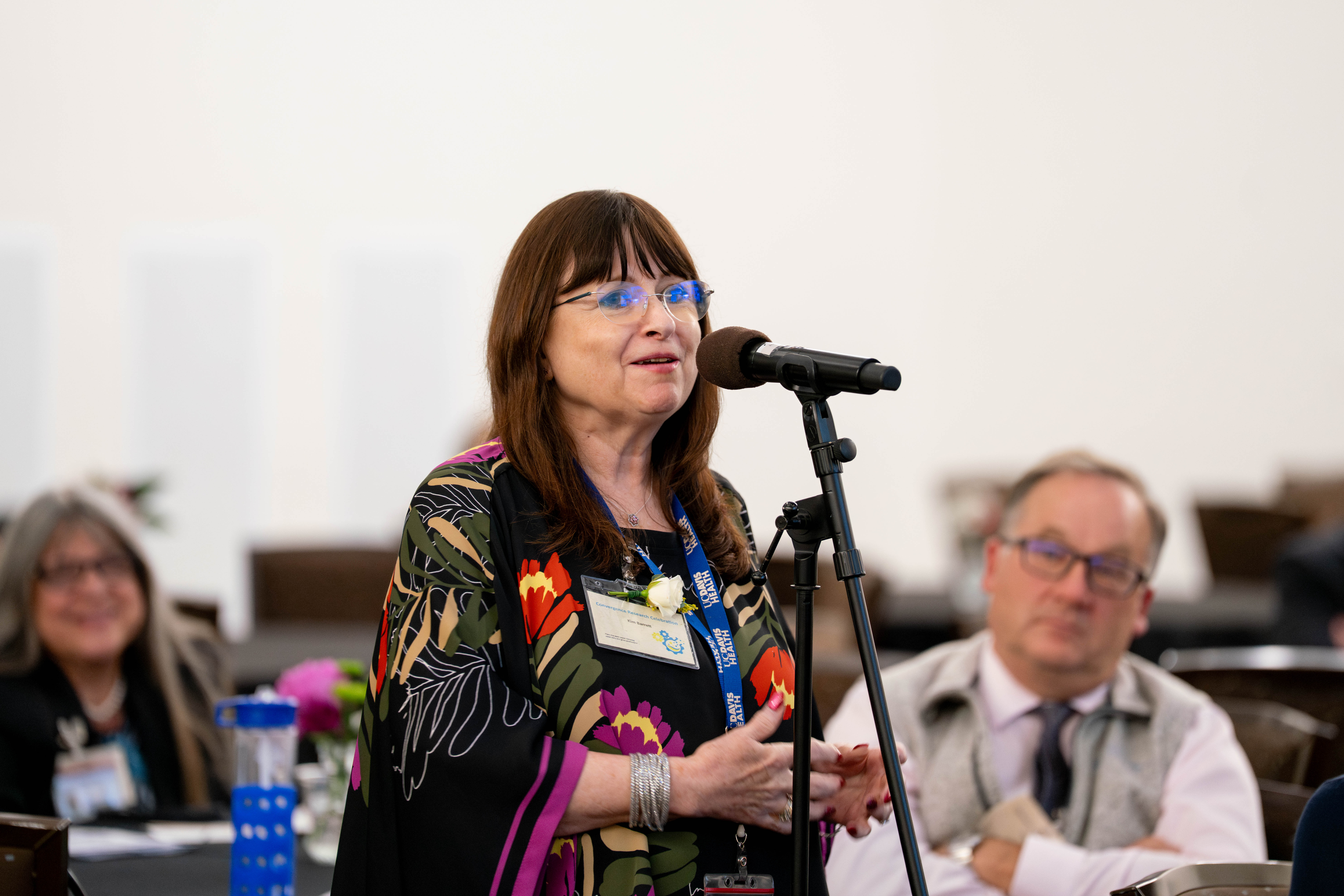 Dressed in a colorful sweater, vice dean for research Kim E. Barrett addressed the crowd