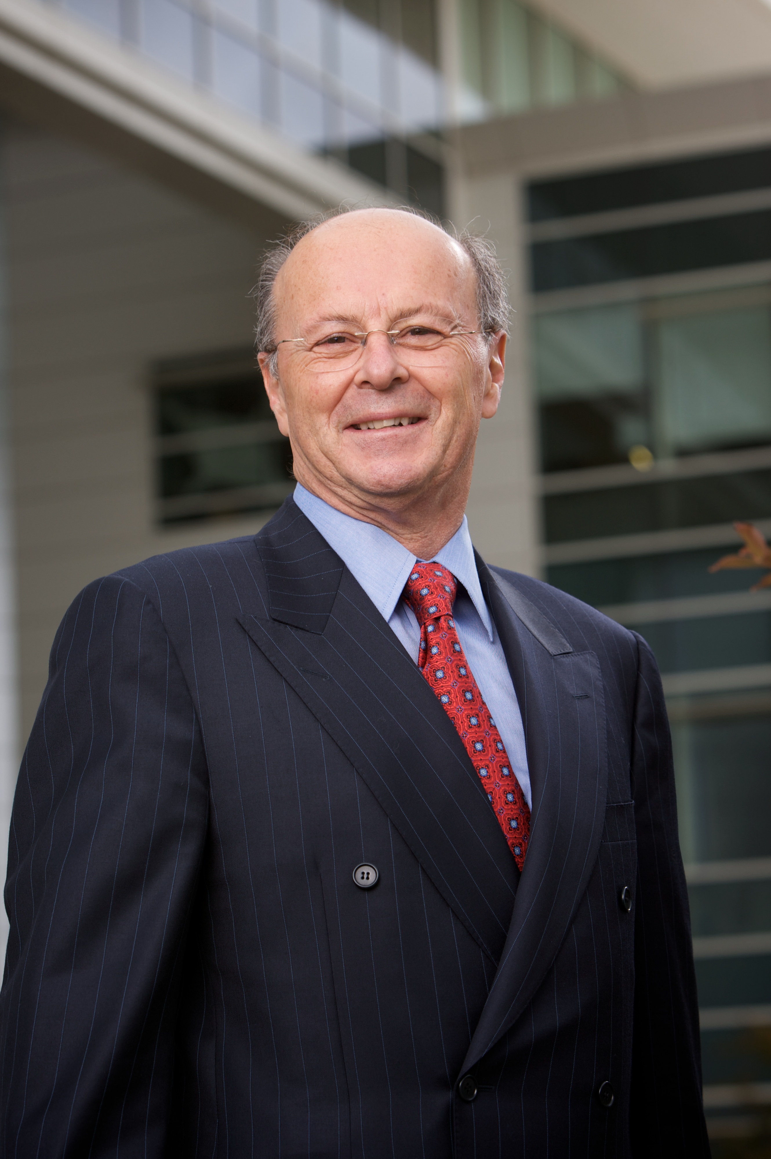 professional photo of a man in a suit smiling to something off camera