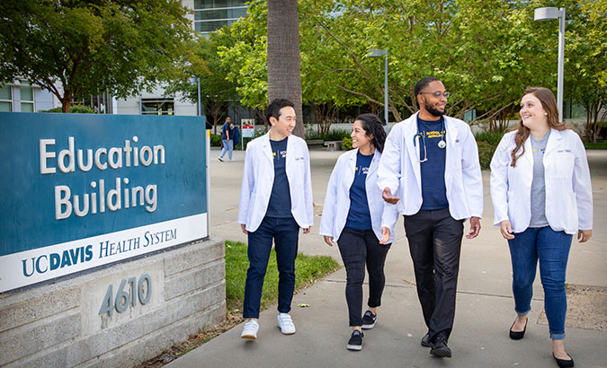 UC Davis medical students walking in front of the education building