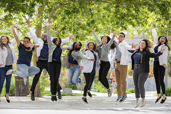 A group of happy UC Davis medical students jumping in synchronity