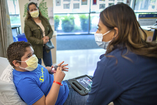 Pediatric patient receiving infusion at the Comprehensive Cancer Center on the UC Davis Health campus