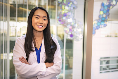 UC Davis medical student Jade Tso, standing in atrium of School of Medicine