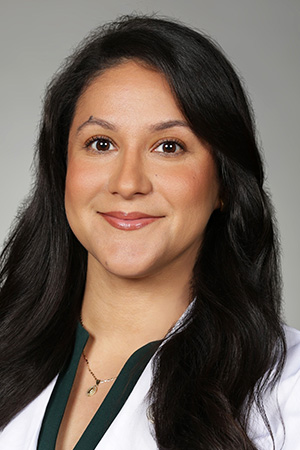 Portrait of medical student Jacqueline Viscarra in white coat and smiling
