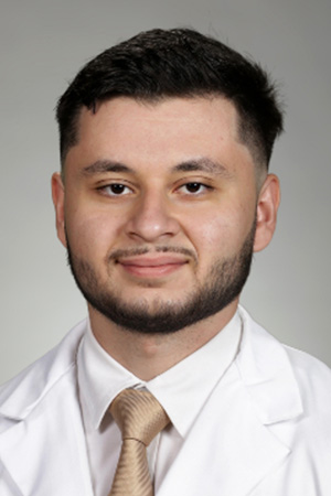 Portrait of medical student Ahmed Zabiba in white coat and smiling