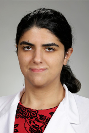 Portrait of medical student Angela Soghomonian in white coat and smiling