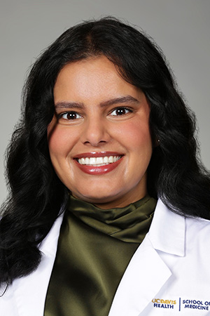 Portrait of medical student Dilvir Sekhon in white coat and smiling
