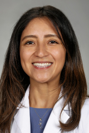 Portrait of medical student Joile Zamudio in white coat and smiling