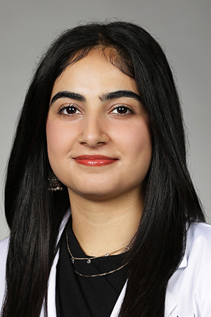 Portrait of medical student Mahnoor Wani in white coat and smiling