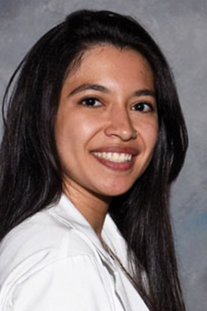 Portrait of medical student Alyssa Fowlds in white coat and smiling