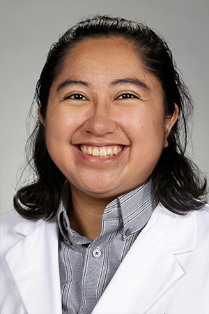 Portrait of medical student Mia Wungnema in white coat and smiling