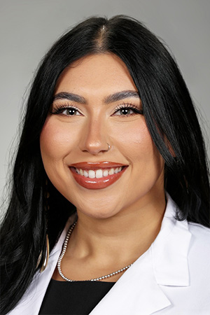 Portrait of medical student Viviana Vega in white coat and smiling