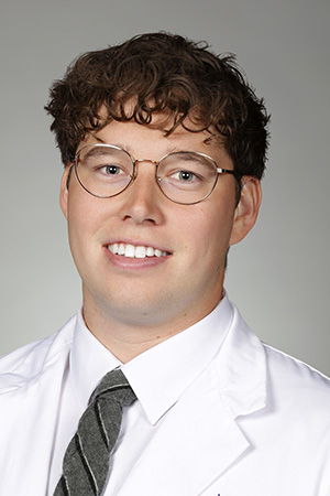 Portrait of medical student Brayden Windes in white coat and smiling