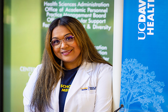 close-up photo of UC Davis female medical student standing in front of education building