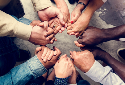 group of people in a circle holding hands