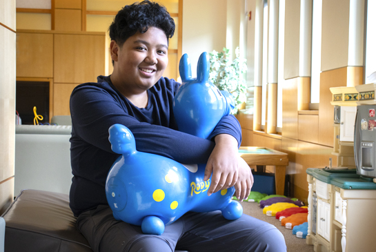 boy sitting with toy in the clinic waiting room