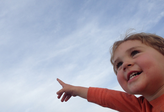 boy pointing at sky