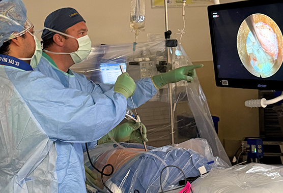 Neurosurgeon teaching a resident about spine surgery