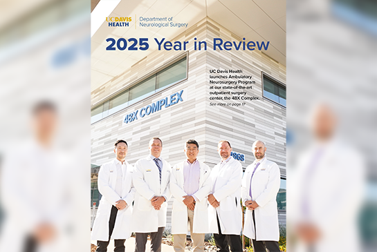 A group of doctors smiling and standing in front of a building