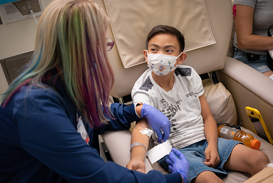 A nurse working with a child.