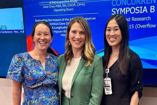 Three nurses at a symposium.