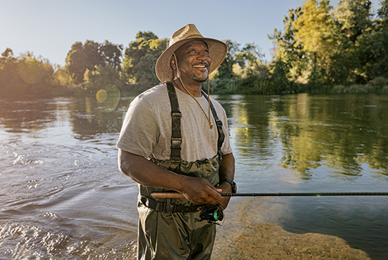 UC Davis Health patient Greg fishing at the river.