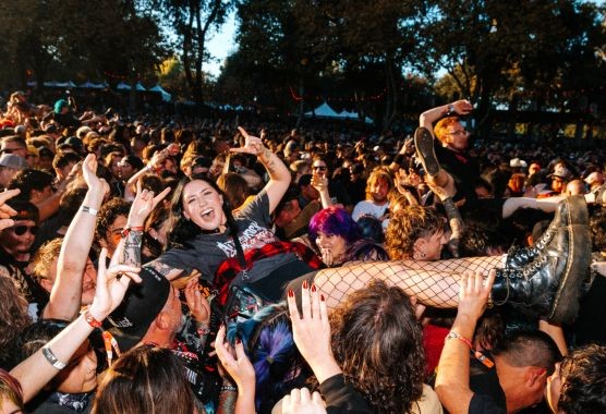 A person crowd surfing at a music festival.