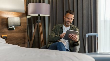 A man scrolling on an iPad