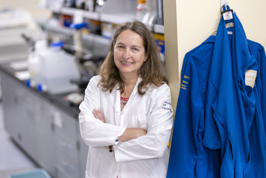 research scientist in a lab coat standing in the lab