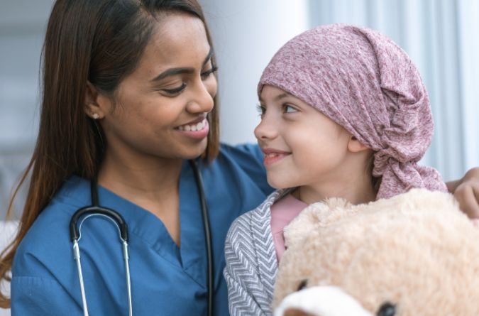 doctor with a child patient with cancer