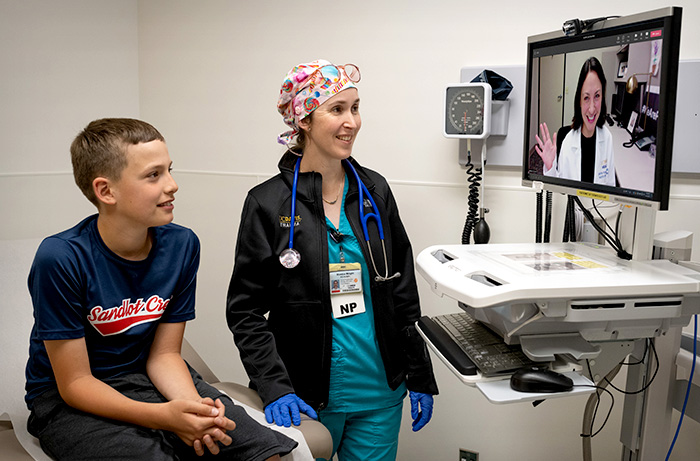 Nurse practitioner with pediatric patient in telehealth consult with UC Davis specialist