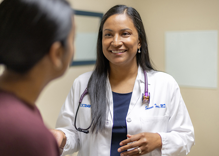 A female UC Davis Health doctor smiles during an office visit