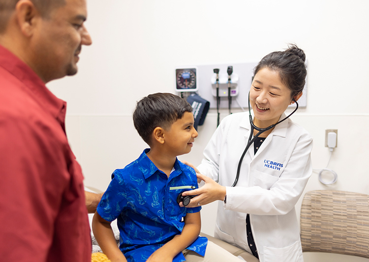 Primary care physician examining pediatric patient