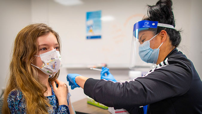 Young girl getting vaccinated at UC Davis Health
