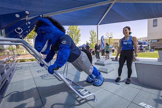 UC Davis Health Mascot Aggie does pushups at new outdoors gym area on campus.