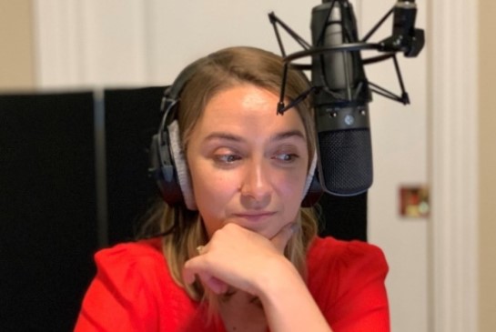 Dr. Lena van der List in podcast studio in front of microphone.