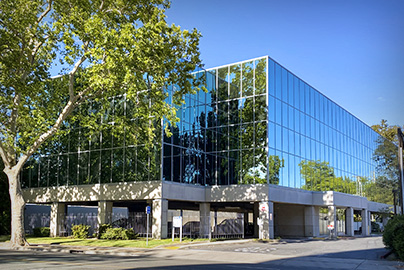 Ticon II, 3 story glass rectangular building.