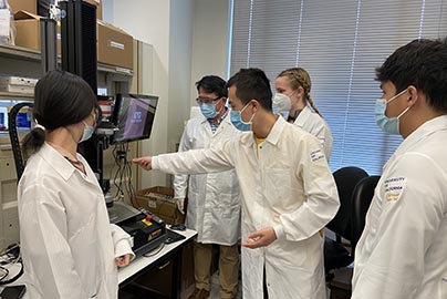 Researchers in lab examine project using research computing equipment.