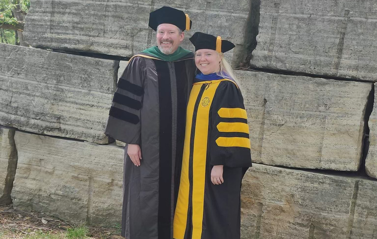 Dr McElroy and graduating resident Shiloh Leuschow, in graduation gowns.