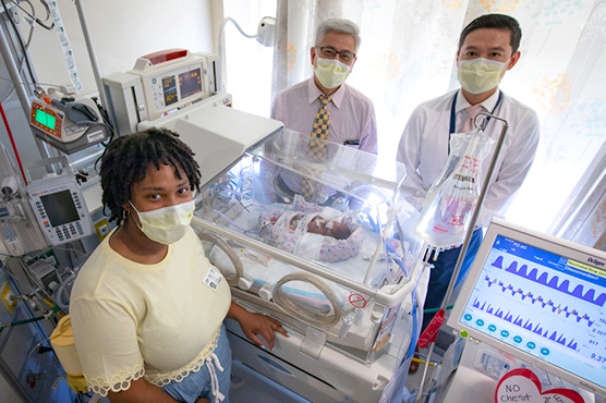 Doctors Ing and Yeh with mother and infant in pediatric cardiology