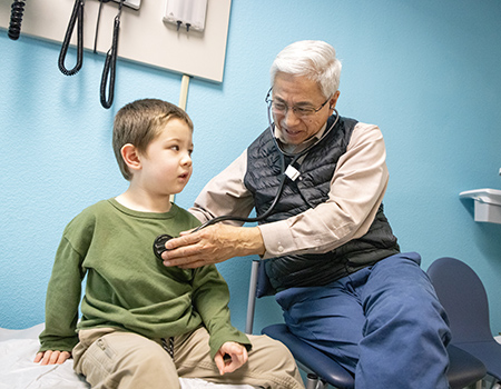 Doctor Frank Ing listens to a patients heart