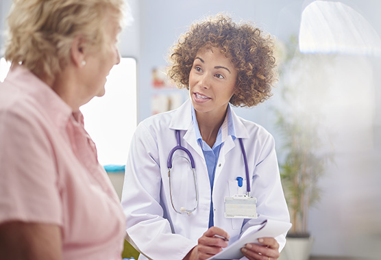 A physician is helping a patient