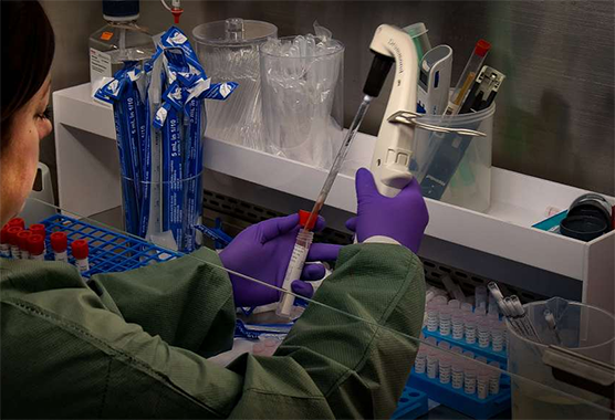 Researcher holding vial
